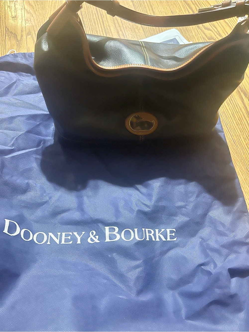 Dooney & Bourke Black Leather Bag with Tan Trim and Tortoiseshell Duck Accent